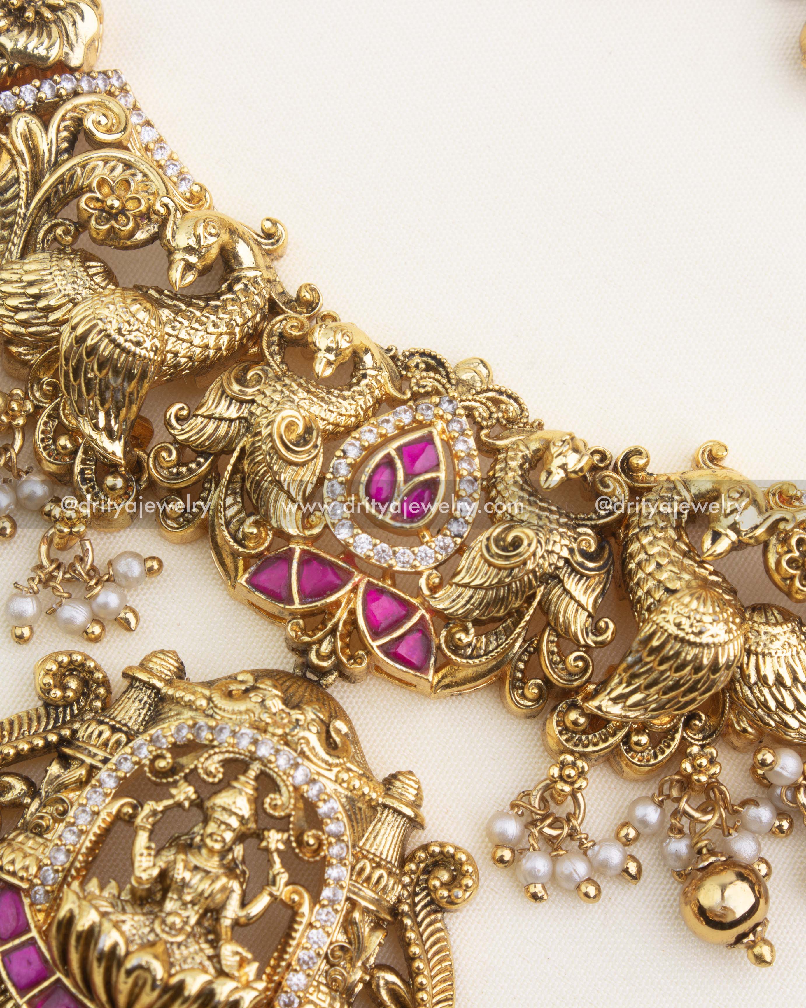 Detailed close-up of Nakshi carving, peacock motifs, ruby kemp inlay, and antique gold finish.