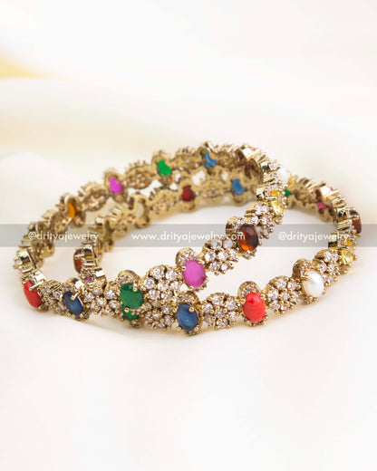 Victorian gold bangles featuring multicolor Navaratna stones and CZ clusters.