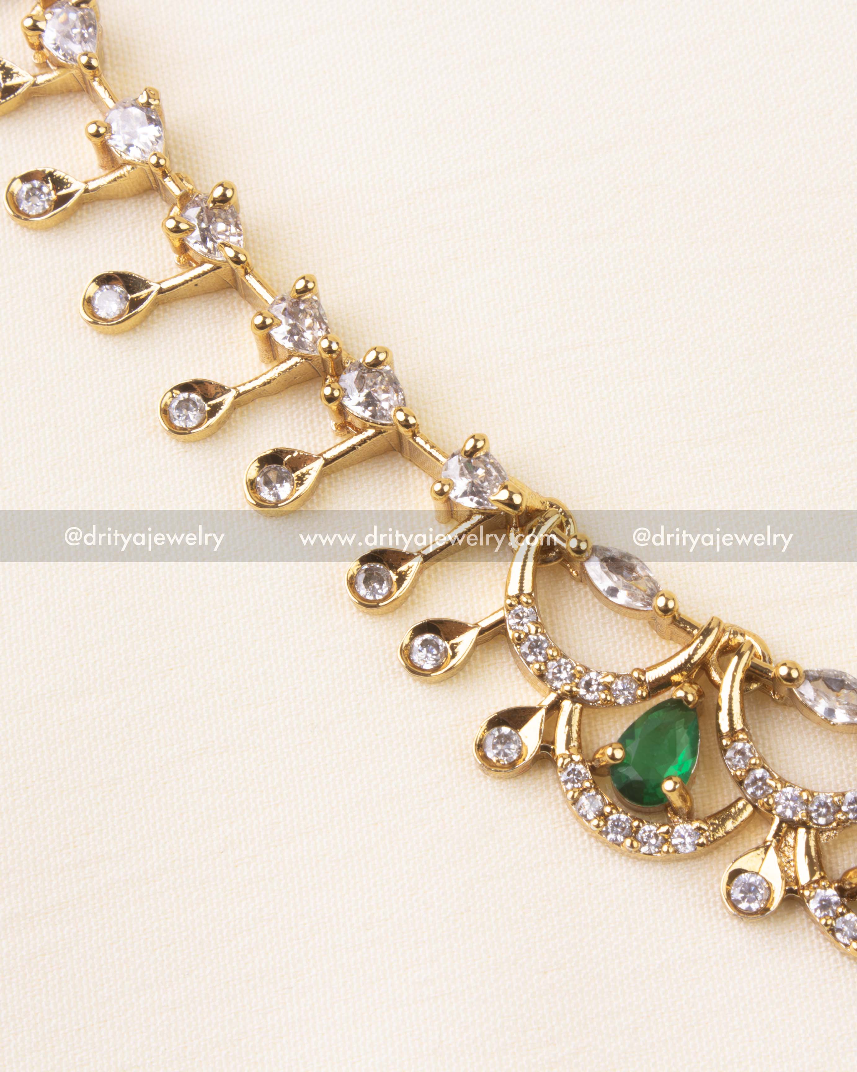 Detailed close-up showing emerald CZ stones with intricate setting.
