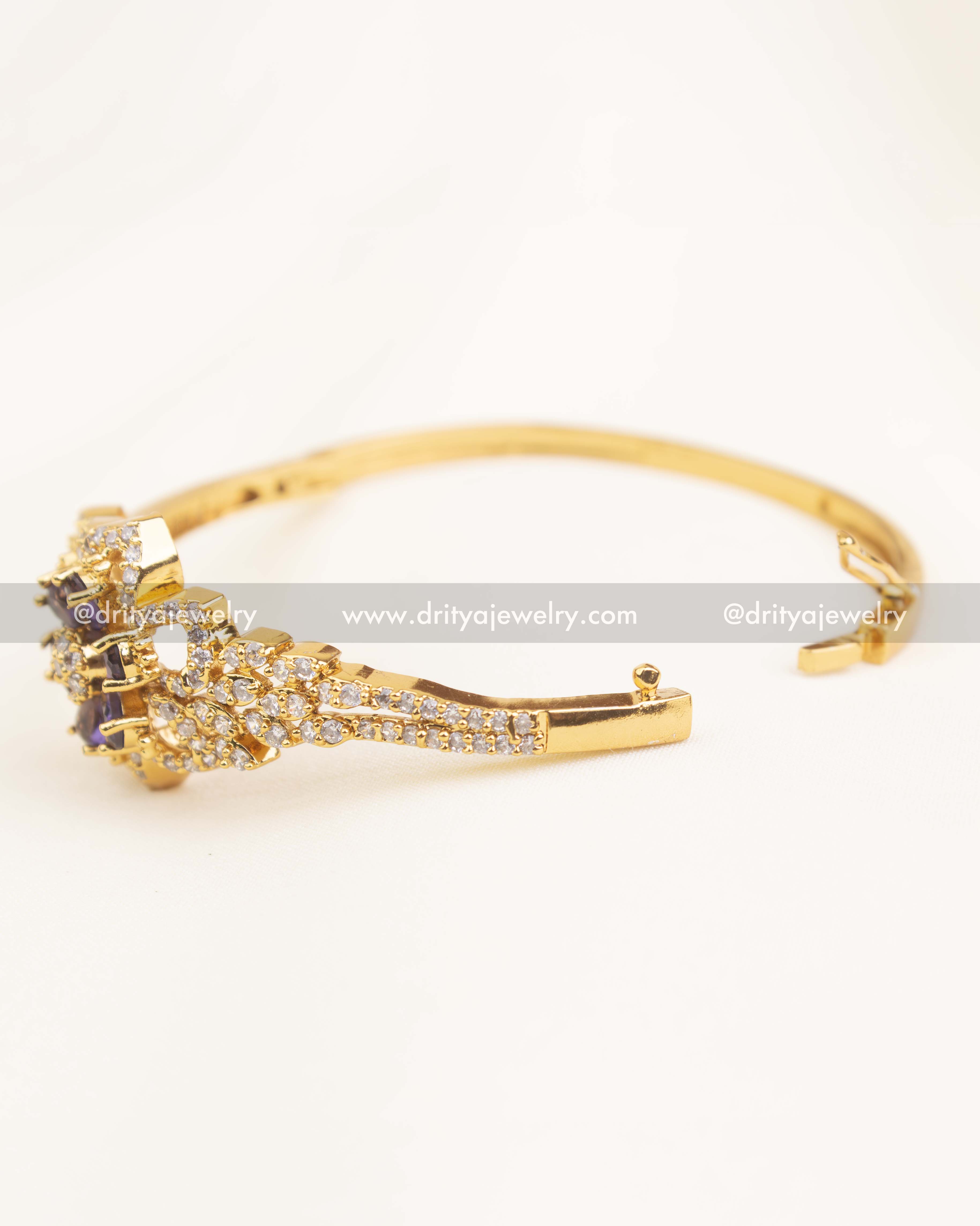 Side angle view of openable CZ kada with purple center motif and secure clasp.