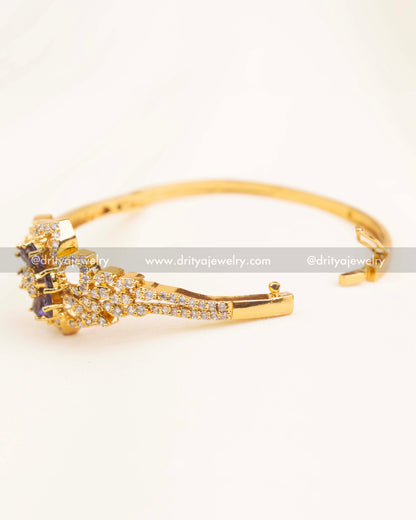 Side angle view of openable CZ kada with purple center motif and secure clasp.