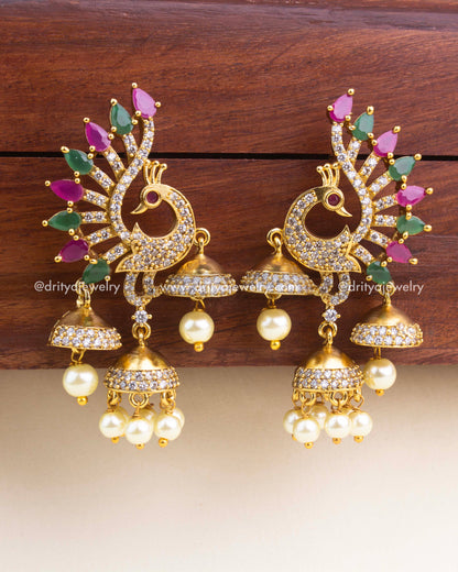 Peacock design CZ earrings with multicolor feather stones and hanging pearl clusters.