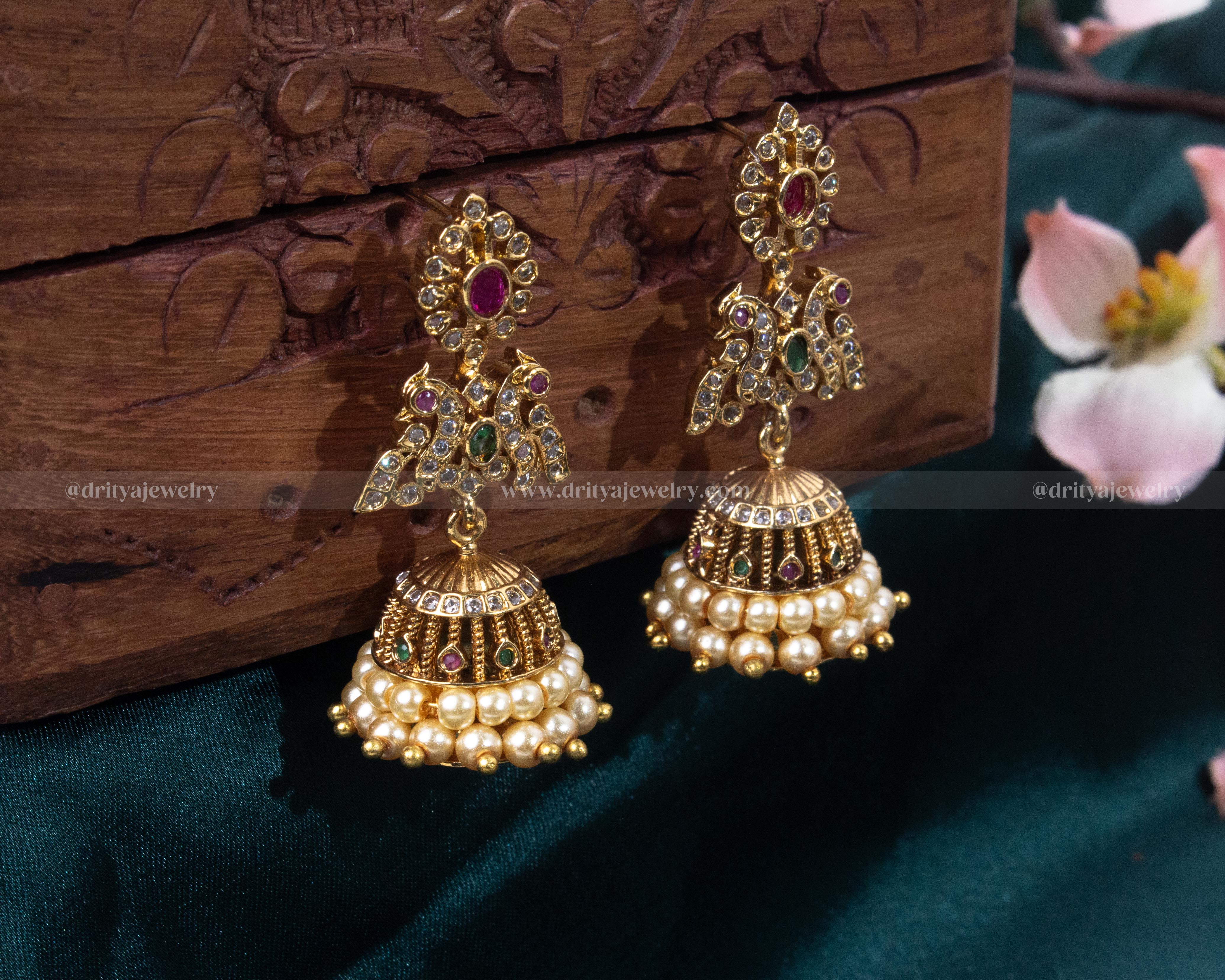 Front view of the Peacock Motif Jhumka Earrings, showcasing detailed gemstone work and pearl accents by Dritya Jewelry.