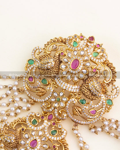 Pearl champaswaralu strands with antique jhumka drop and textured bead detailing.