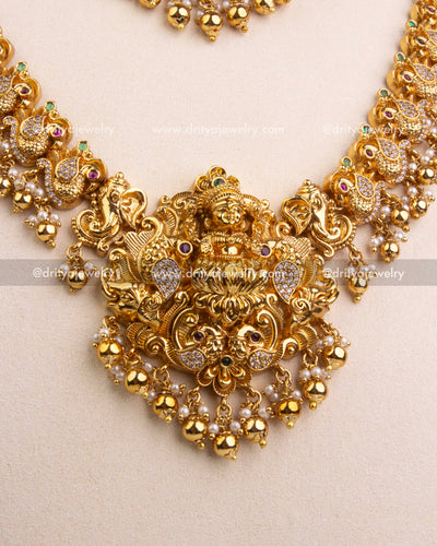 Close-up of Lakshmi Devi pendant with intricate motifs and golden bead drops.