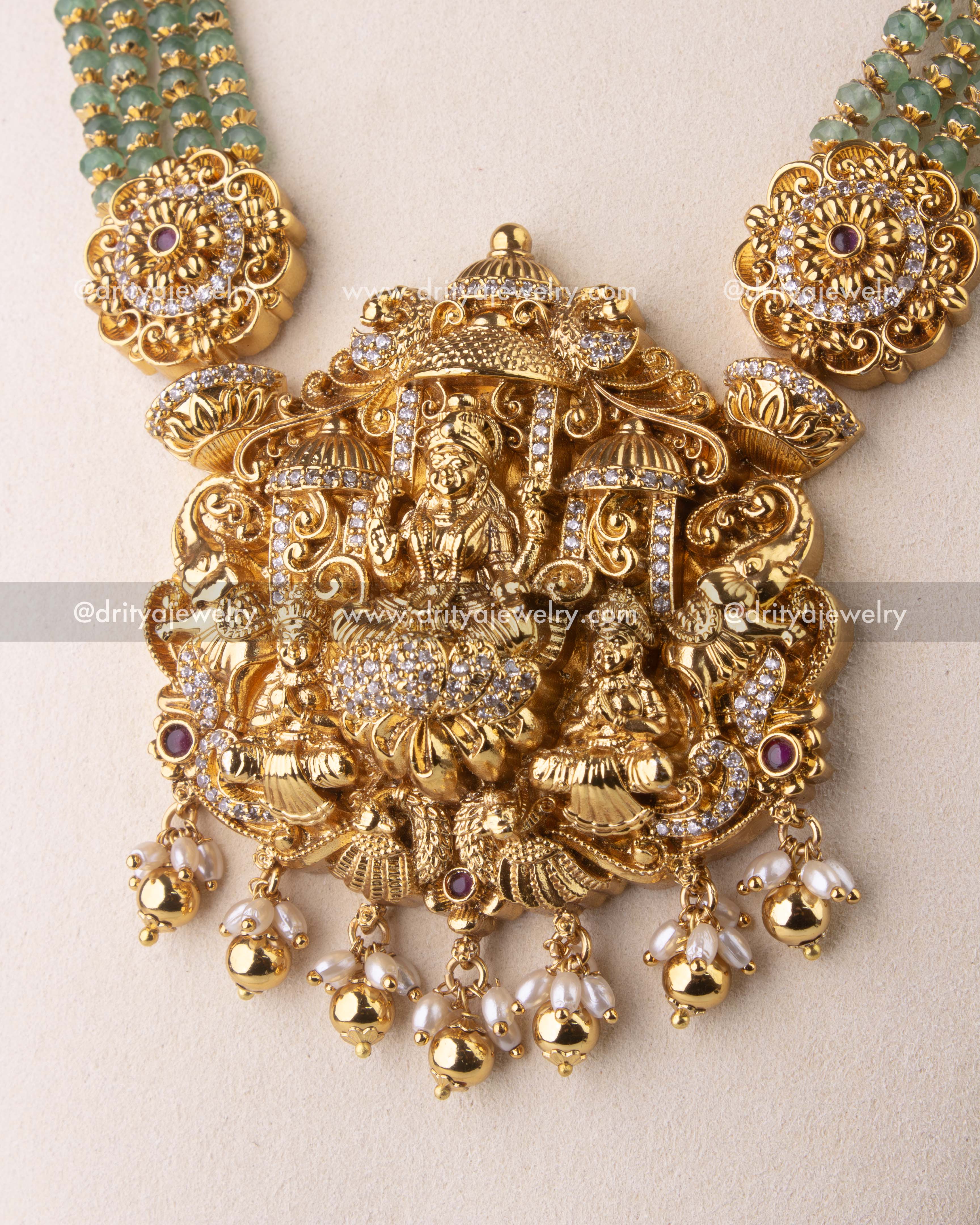 Intricate Lakshmi Devi pendant with pearl and gold bead danglers.