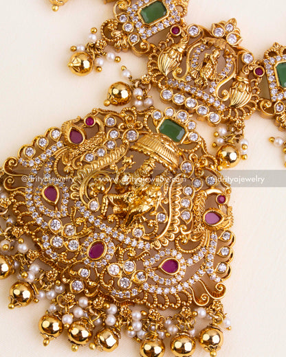 Statement pendant with Lord Narasimha in arch frame, embellished with CZs, ruby accents, and gold ball hangings.