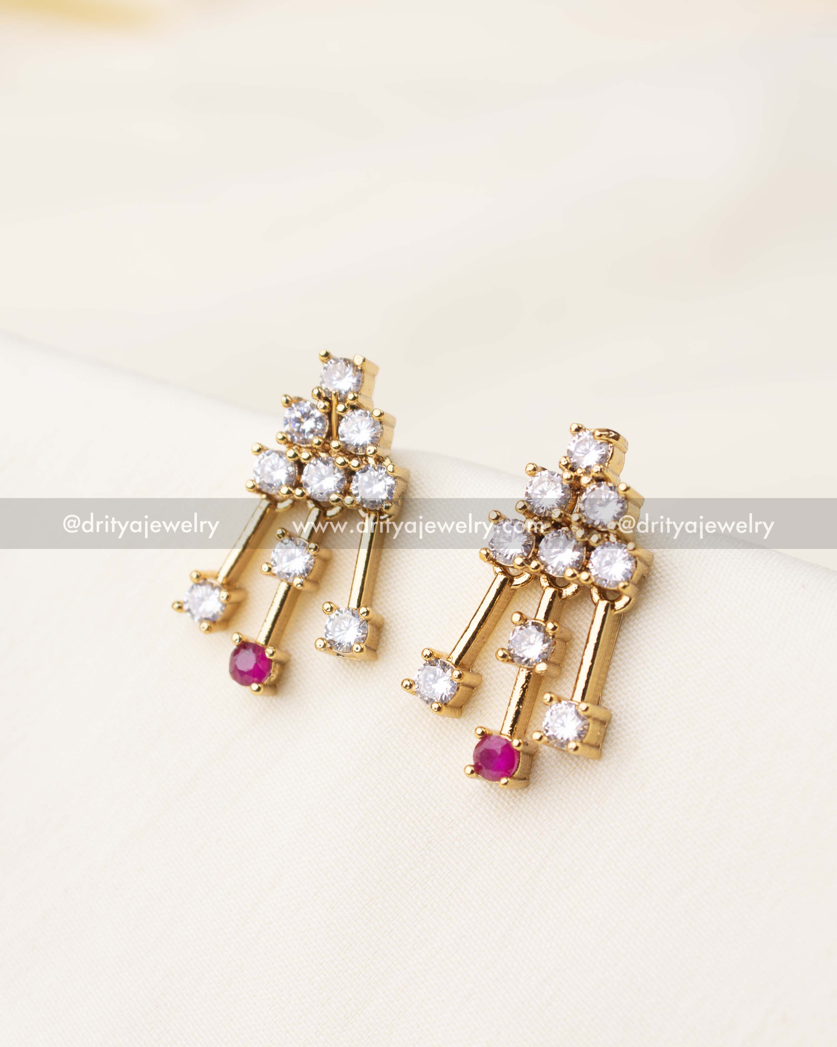 Pair of short gold earrings with pink and white CZ stones in a linear drop design.