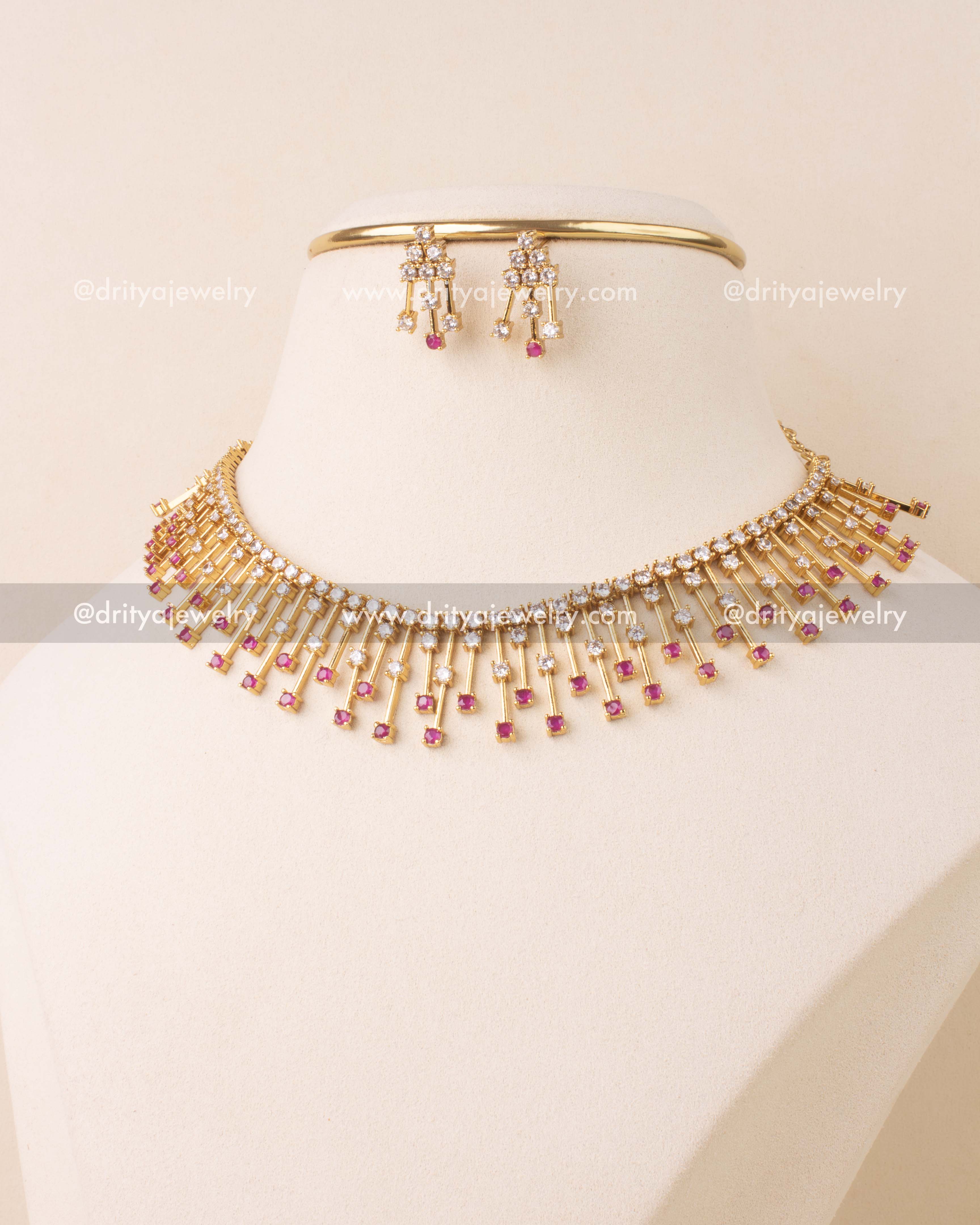 Gold-plated short necklace set with pink and white CZ stones and matching drop earrings.