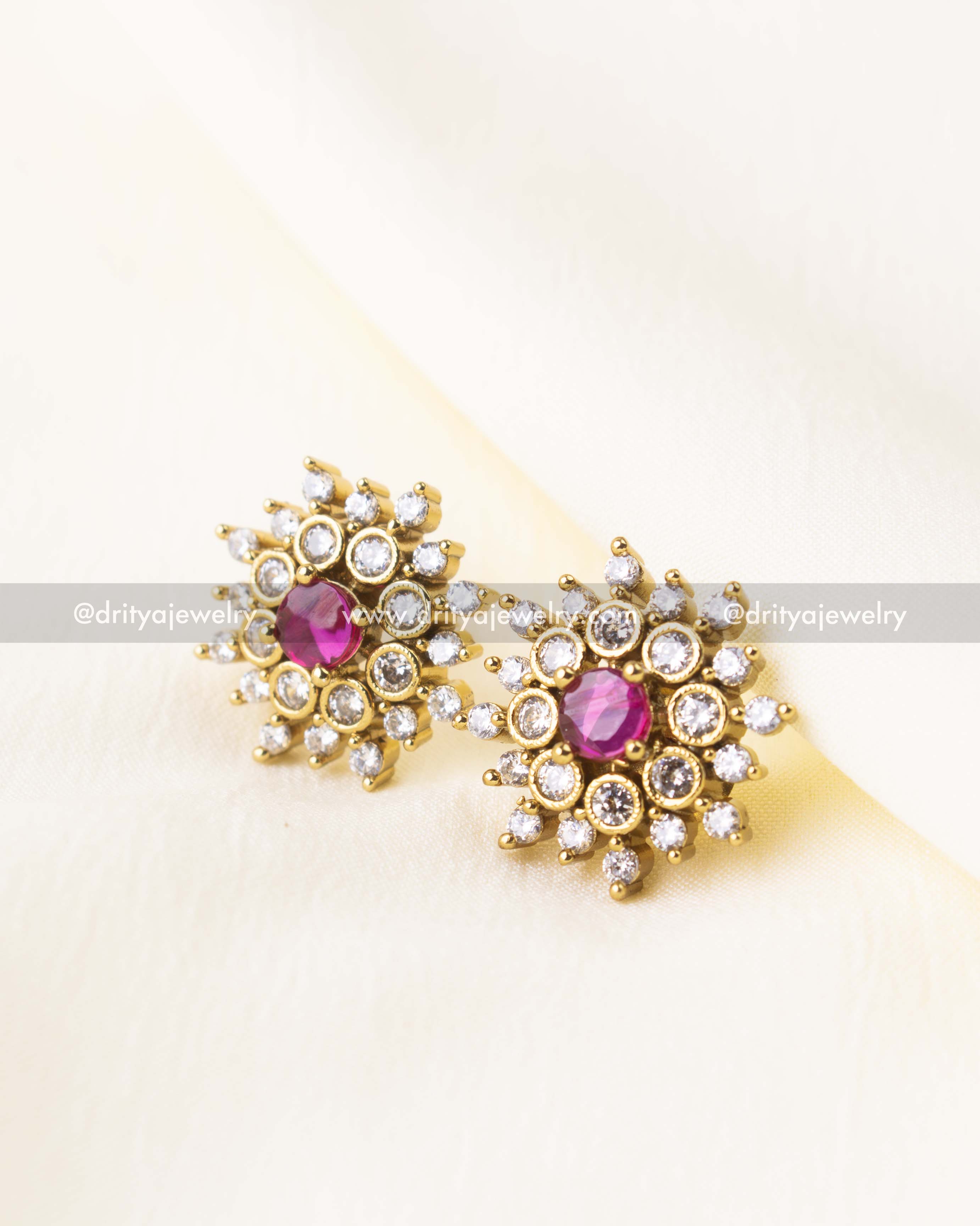 Minimalist gold-finish pink CZ studs with a halo of sparkling crystals.