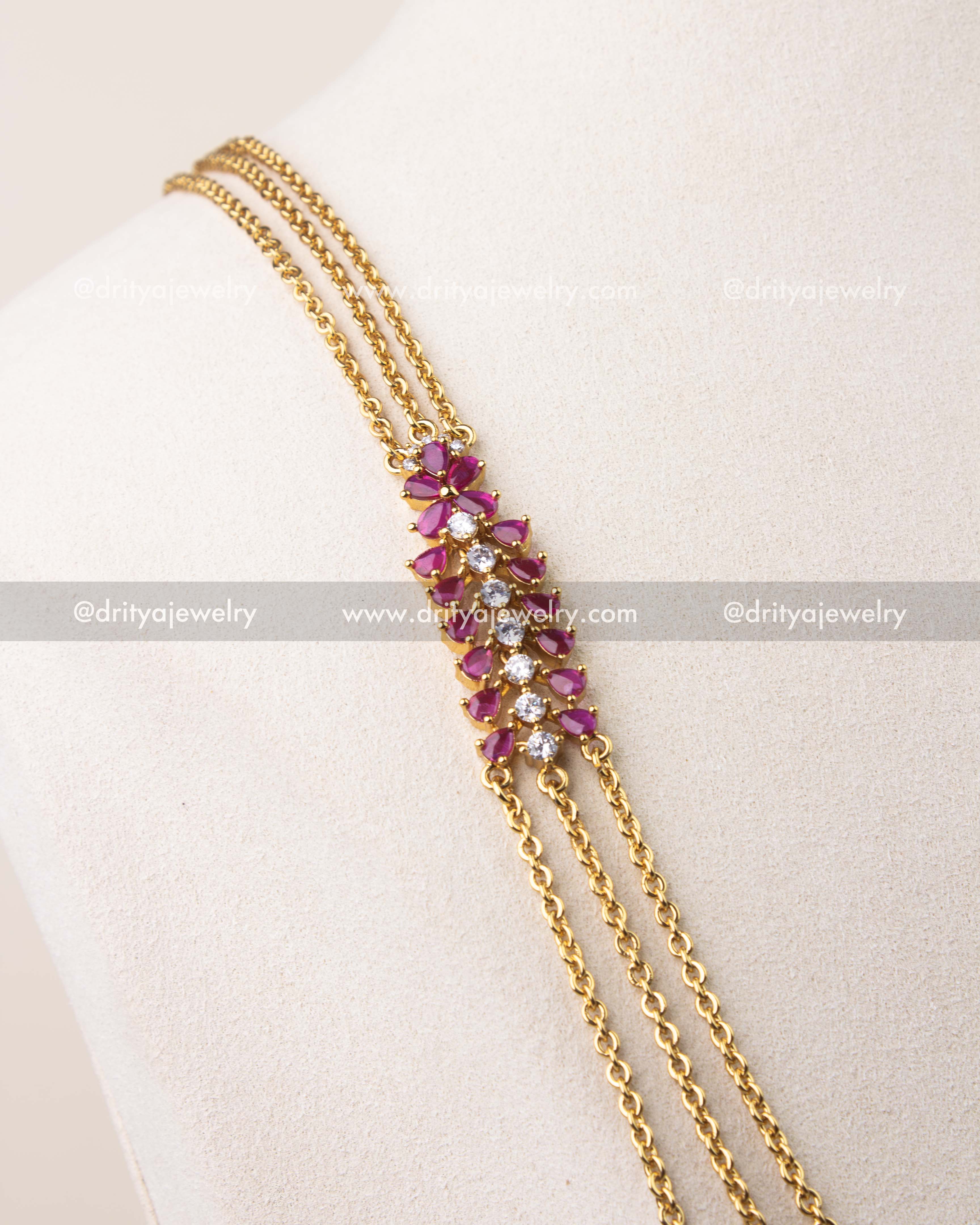 Close-up of ruby pink cushion cut stones with CZ detailing on chandraharam necklace