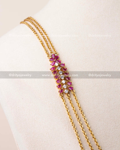 Close-up of ruby pink cushion cut stones with CZ detailing on chandraharam necklace