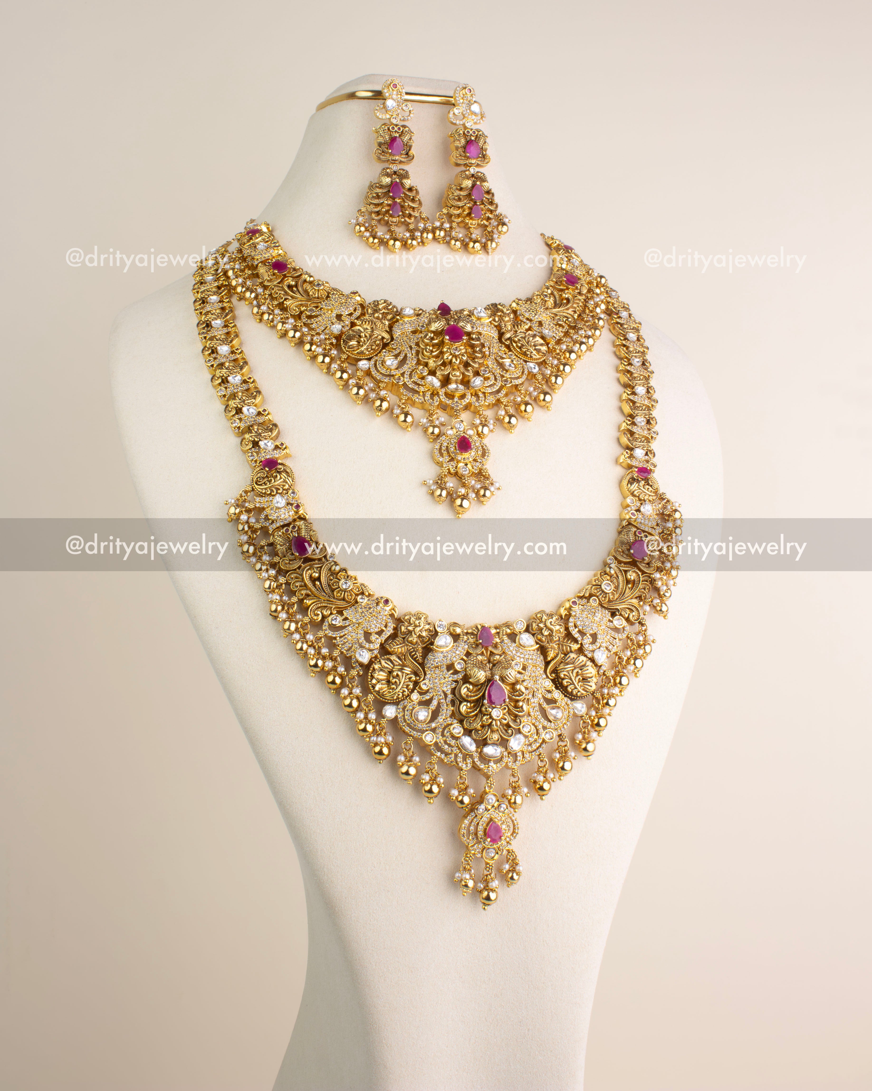 Complete bridal-style antique jewelry combo set featuring long necklace, short necklace, and matching danglers with ruby-red stones and kundan embellishments.