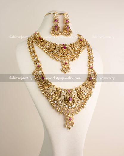 Complete bridal-style antique jewelry combo set featuring long necklace, short necklace, and matching danglers with ruby-red stones and kundan embellishments.