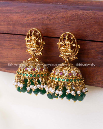 Detailed view of Jhumka dome with ruby and emerald accents, pearl clusters, and green bead drops.