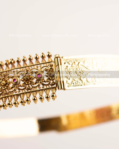 Side view showing detailed floral filigree pattern and gold-plated temple craftsmanship.