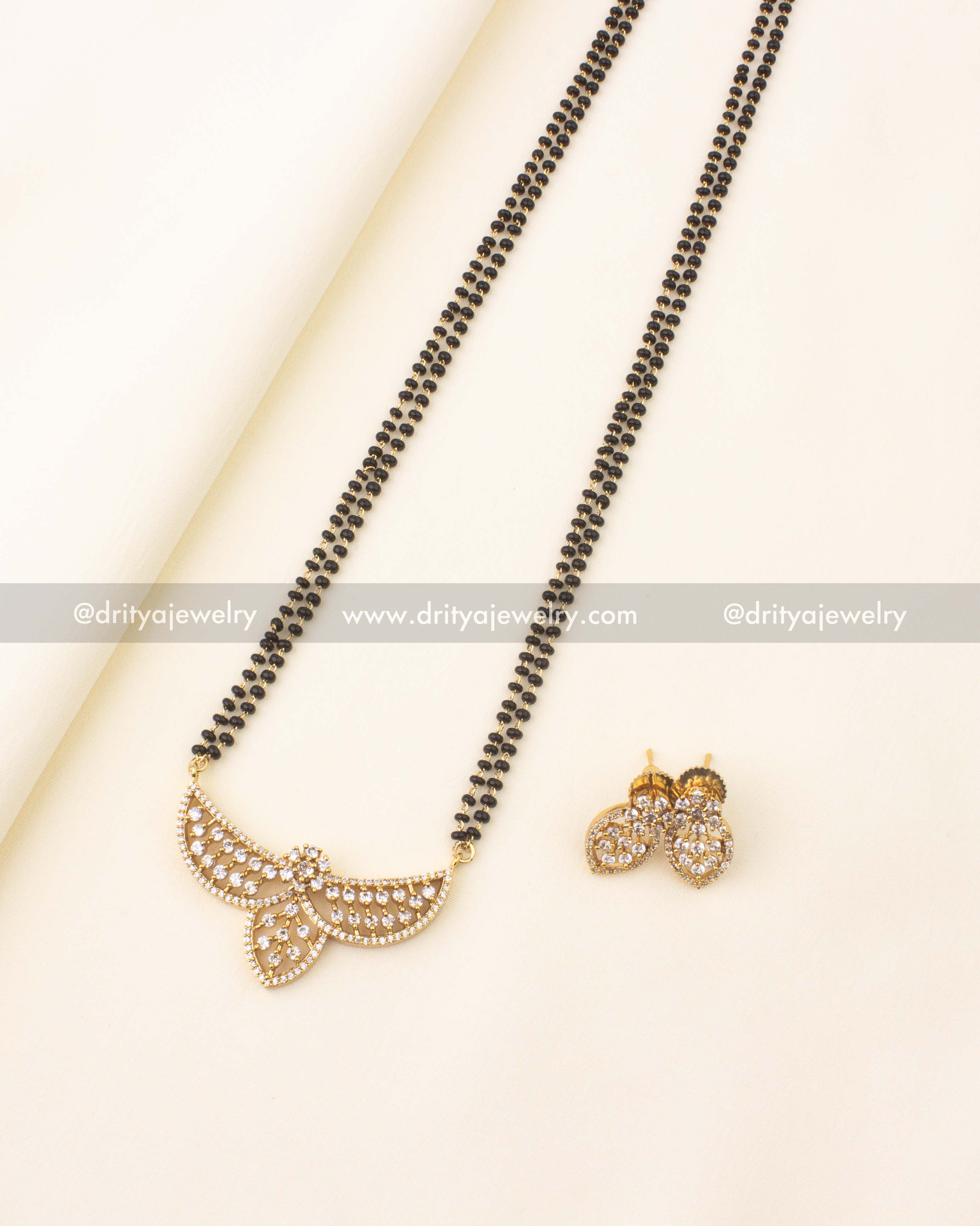 Elegant 24-inch black beads necklace with CZ stone pendant and gold finish.