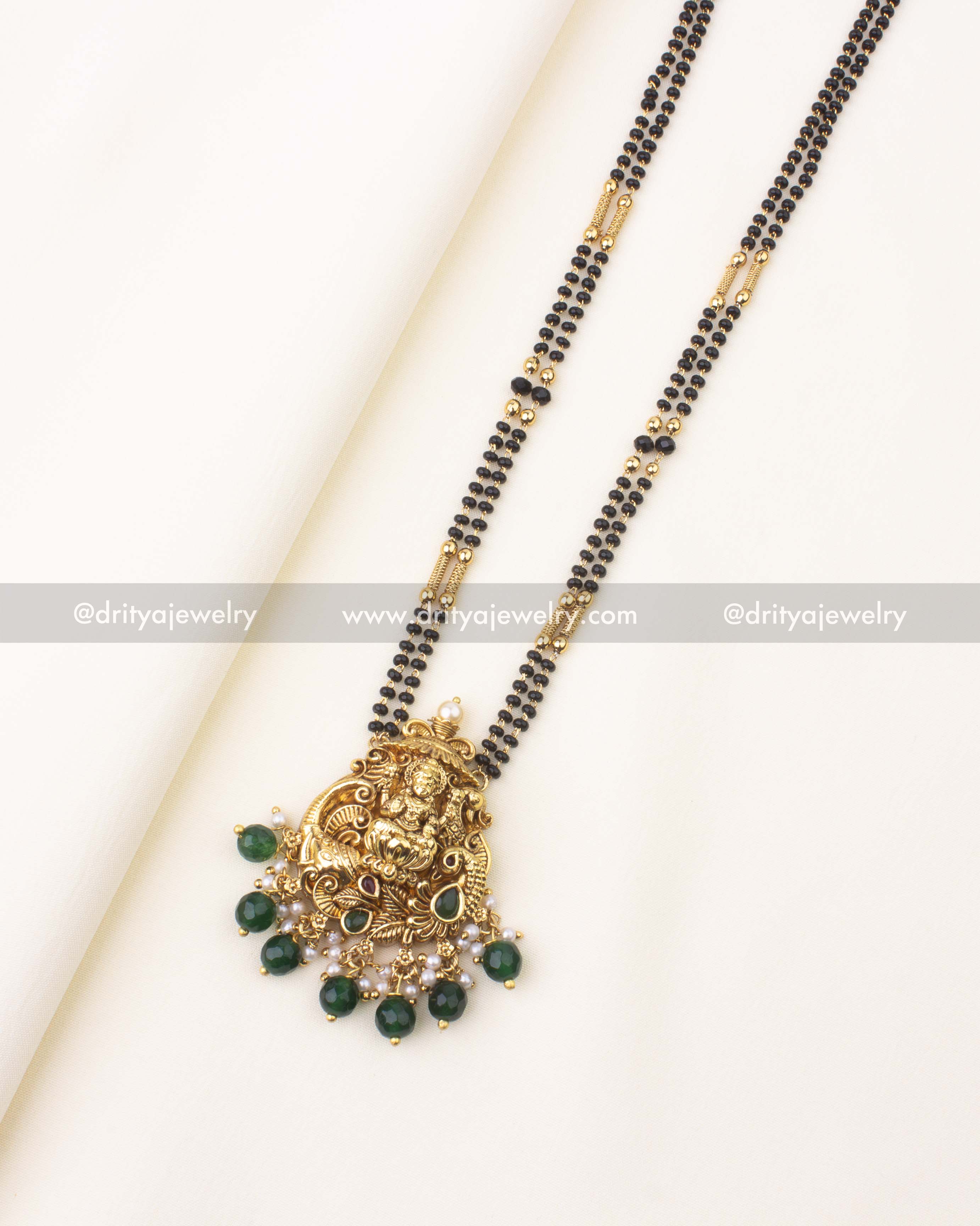 Double-layer black beads necklace with temple-style Goddess Lakshmi Nakshi pendant.