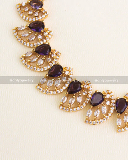 Close-up of purple teardrop stones with CZ border detailing.