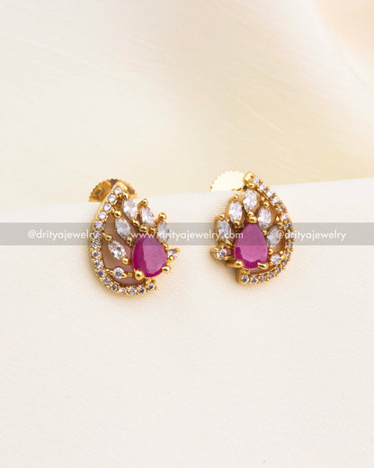 Ruby red stud earrings with gold base and white CZ border.