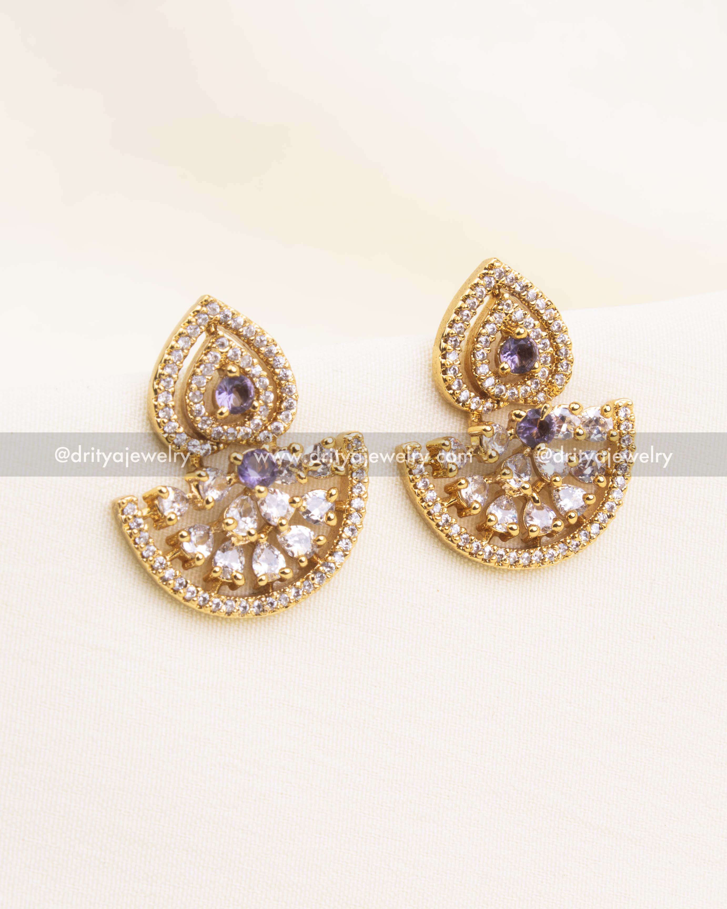 Gold-plated CZ earrings with purple gemstone and teardrop-crescent design.