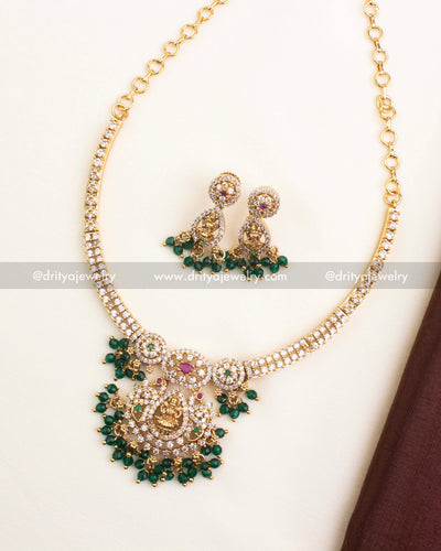 Gold-plated CZ temple short necklace featuring Lakshmi pendant, ruby-emerald accents, and green bead drops.