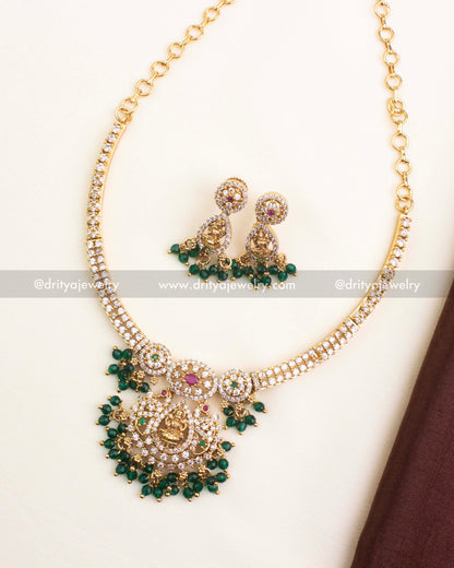 Gold-plated CZ temple short necklace featuring Lakshmi pendant, ruby-emerald accents, and green bead drops.