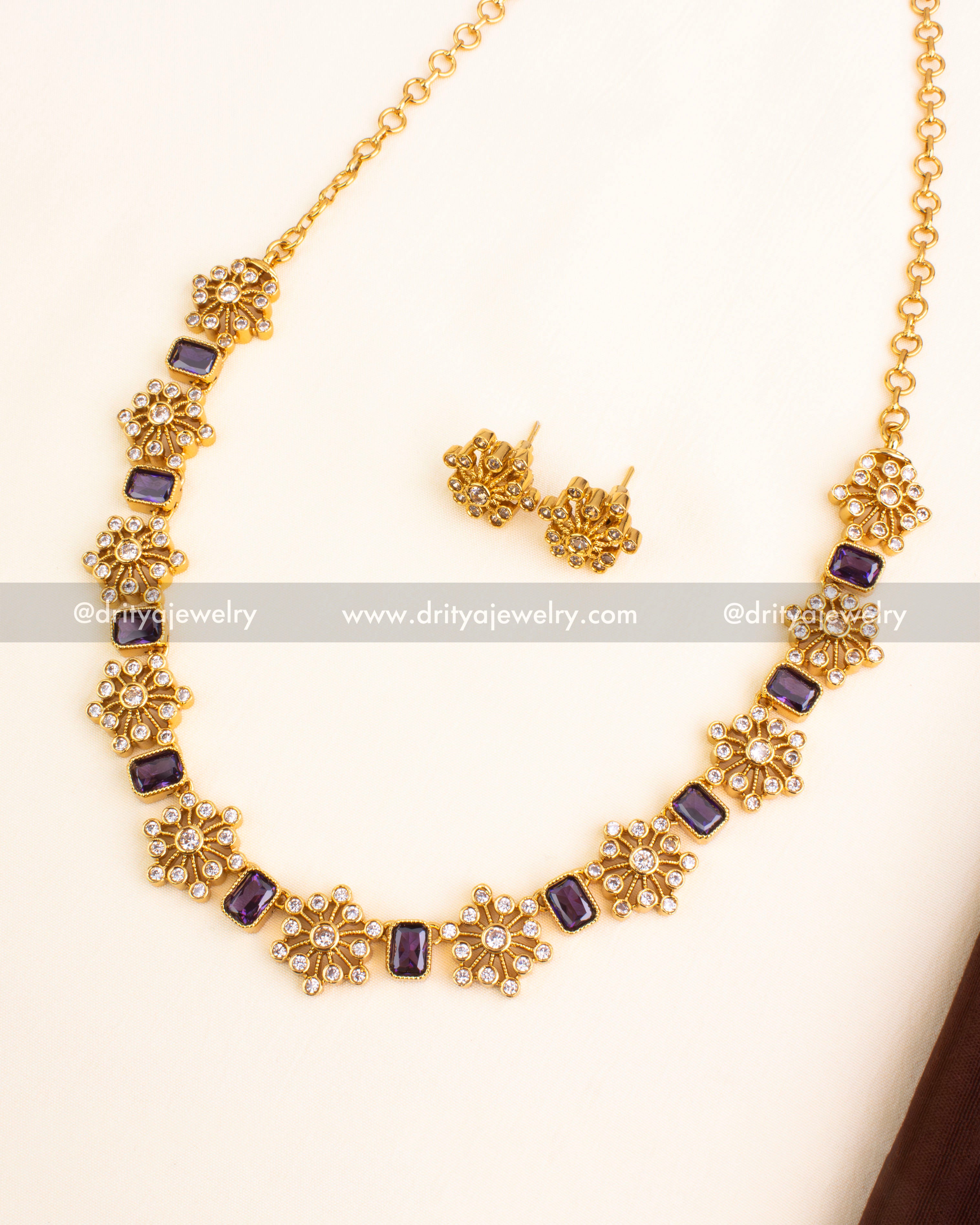 Floral short necklace featuring gold plating, purple rectangular stones, and matching studs