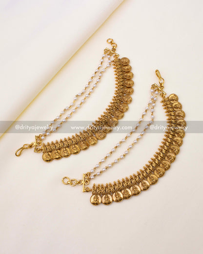 Antique gold champa swaralu with Lakshmi coin motifs, peacock designs, and pearl chains.