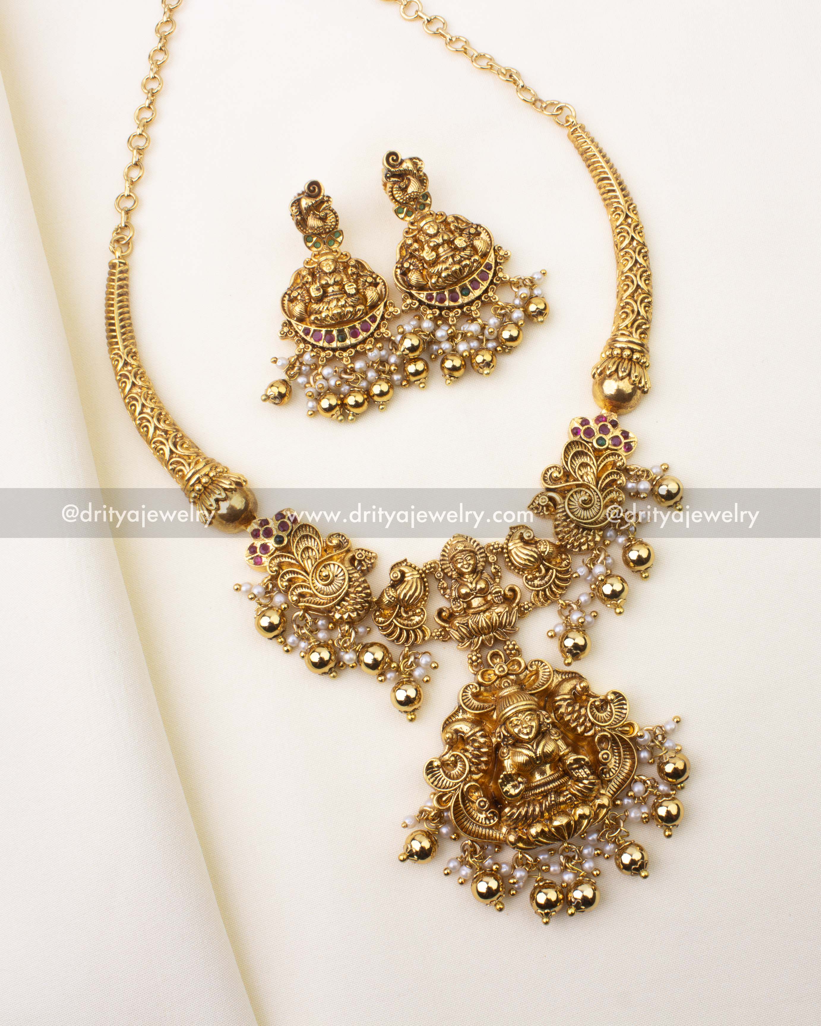 Gold-plated Kanti short necklace featuring Goddess Lakshmi motif, nakshi detailing, and pearl-golden bead drops.