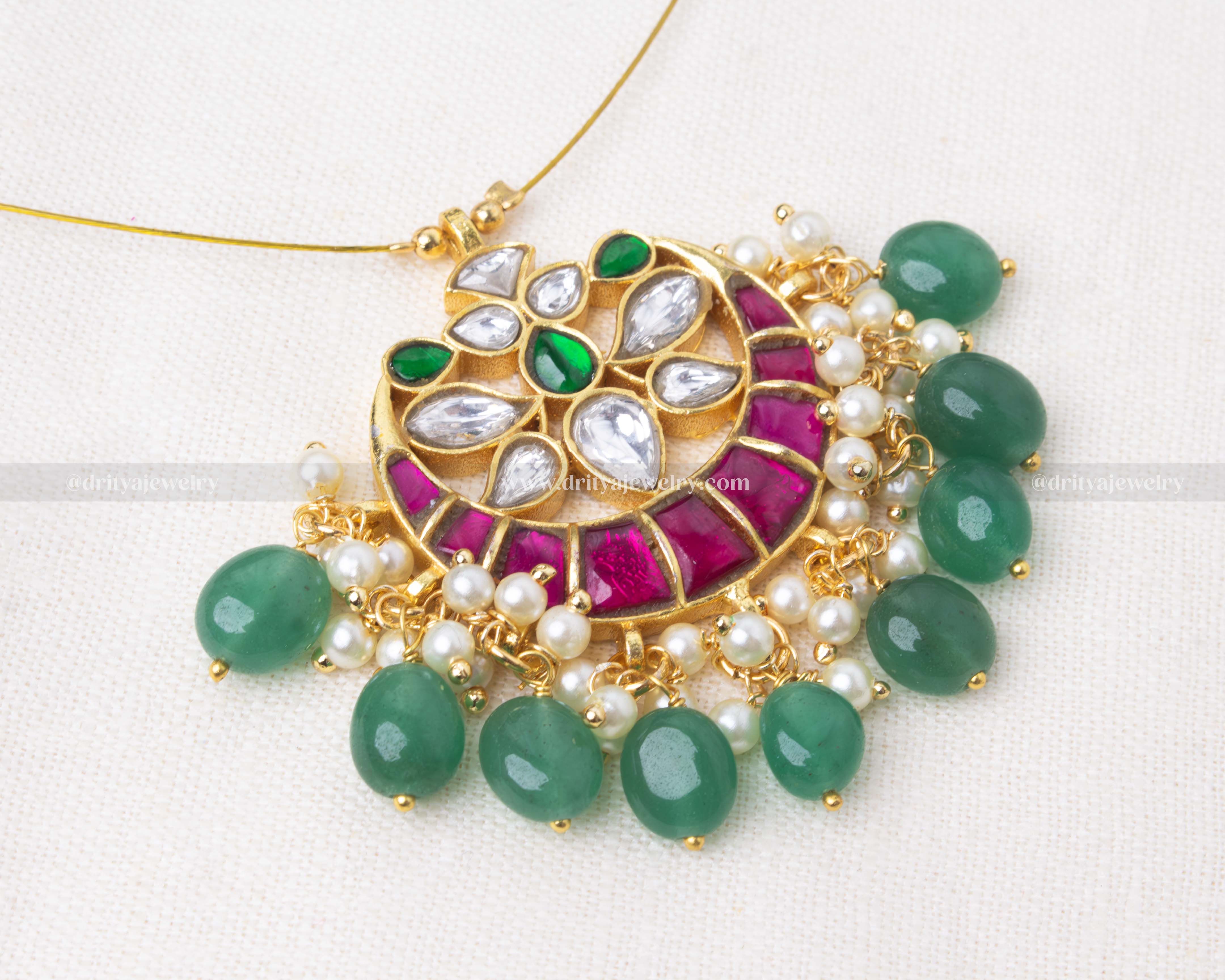 Jadua kemp necklace with gold plating, pink and green stone detailing, and pearl accents.