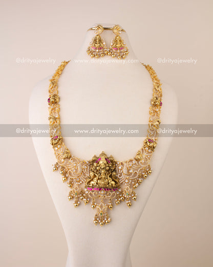 Nakshi long necklace featuring Goddess Lakshmi pendant, Kemp accents, CZ stones, and golden bead drops.
