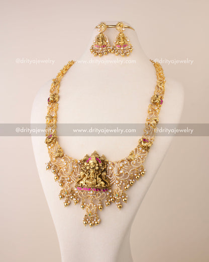 Nakshi long necklace featuring Goddess Lakshmi pendant, Kemp accents, CZ stones, and golden bead drops.