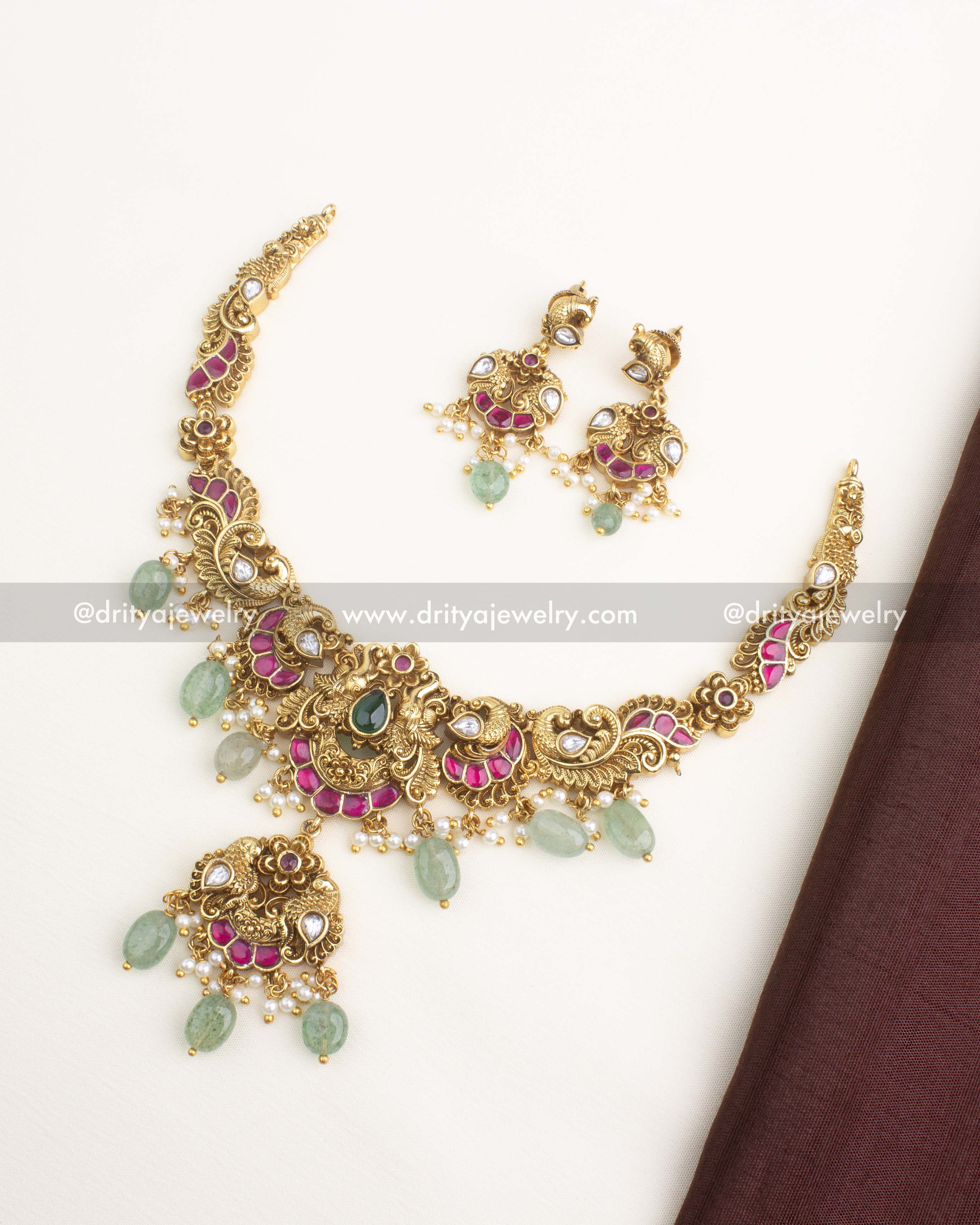 Antique gold kemp short necklace with polki kundan stones, peacock motifs, green bead drops, and matching earrings