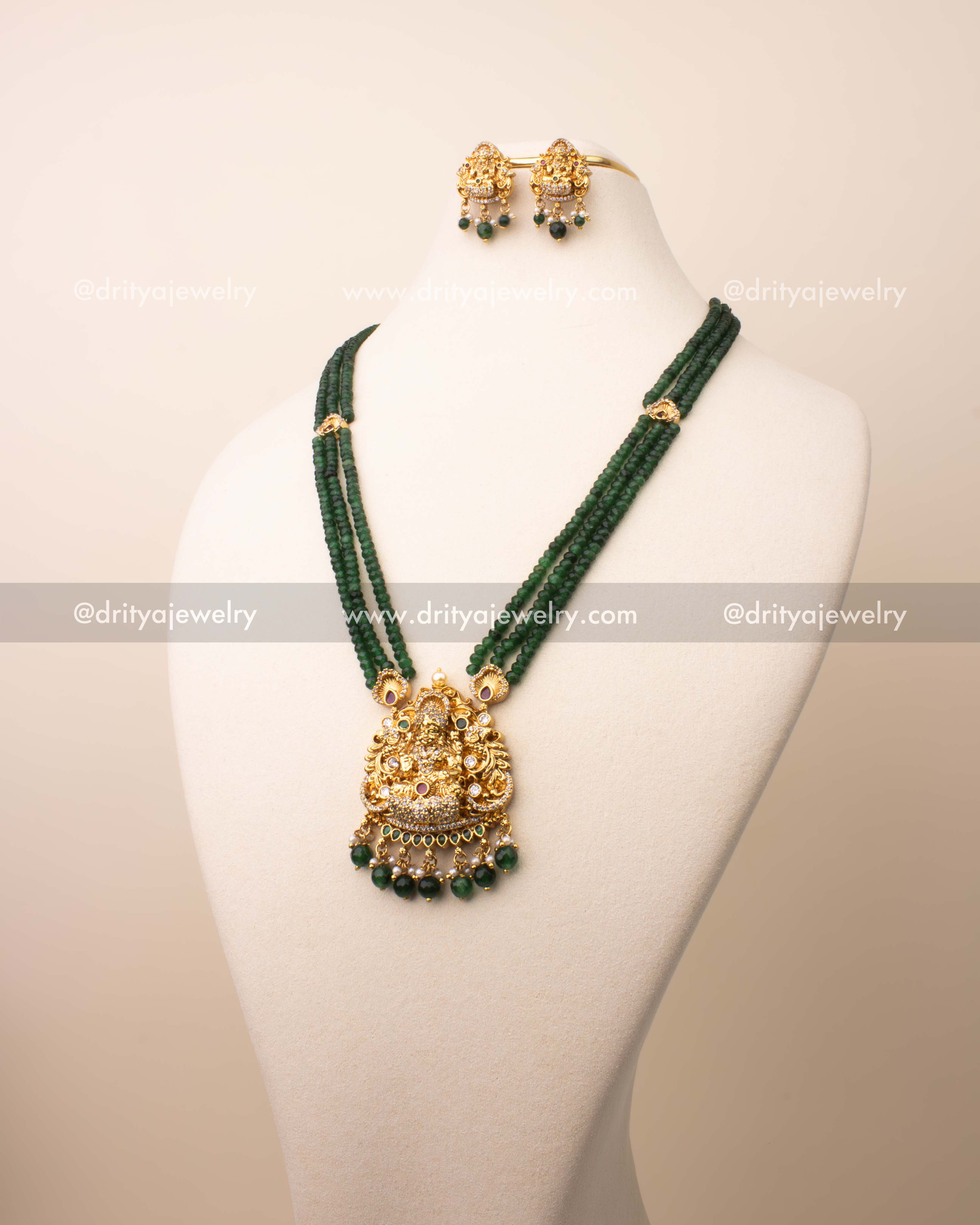 Triple-layer green crystal bead necklace with Goddess Lakshmi pendant in antique temple finish.