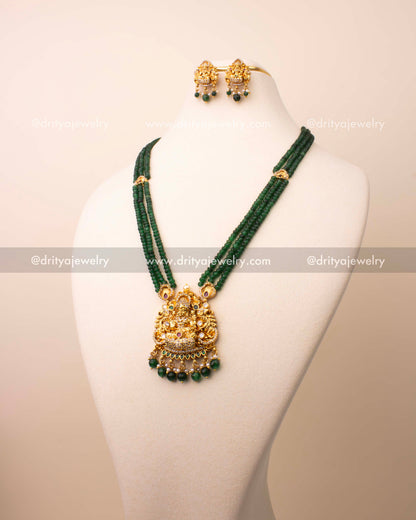 Triple-layer green crystal bead necklace with Goddess Lakshmi pendant in antique temple finish.