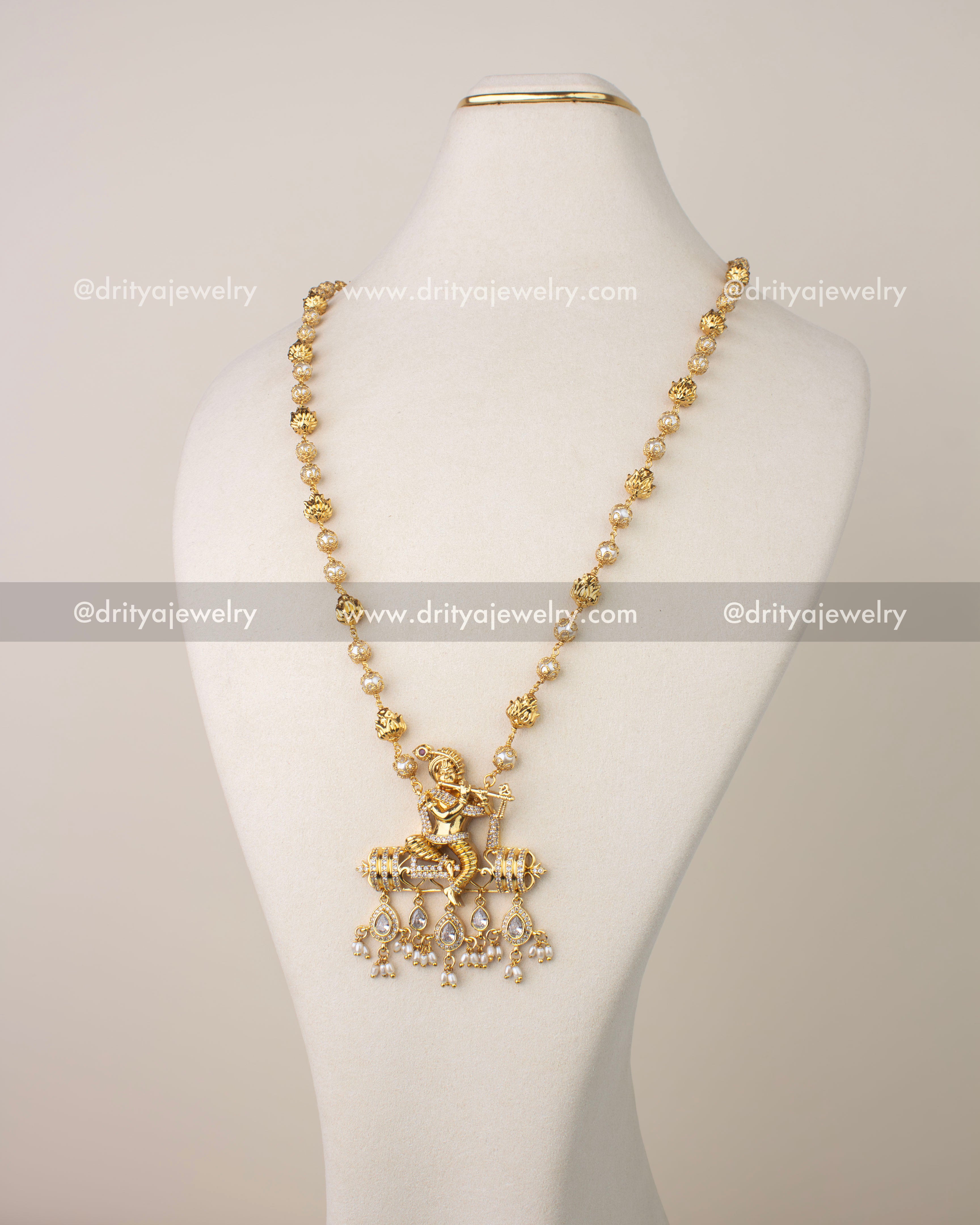 Gold-plated necklace with Lord Krishna pendant, CZ detailing, and pearl drops.