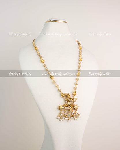 Gold-plated necklace with Lord Krishna pendant, CZ detailing, and pearl drops.