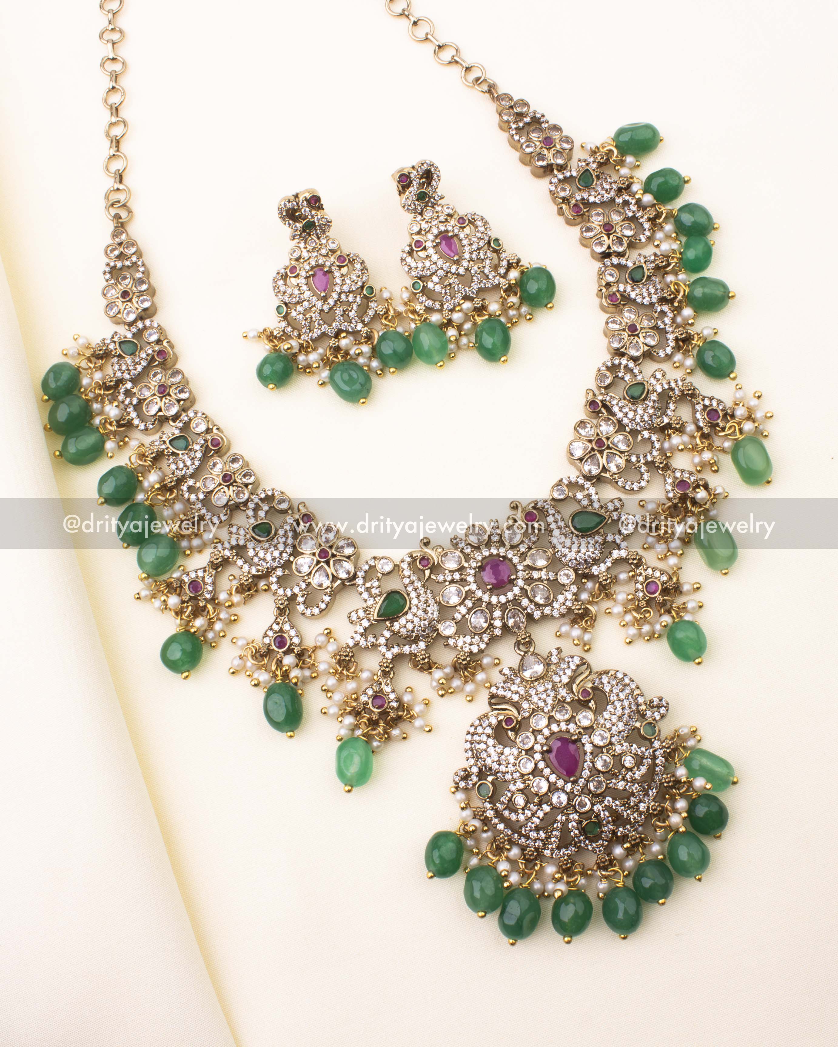 Victorian short necklace set with CZ stones, ruby-red highlights, emerald bead drops, and antique finish.