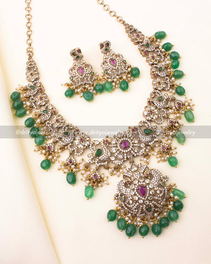 Victorian short necklace set with CZ stones, ruby-red highlights, emerald bead drops, and antique finish.