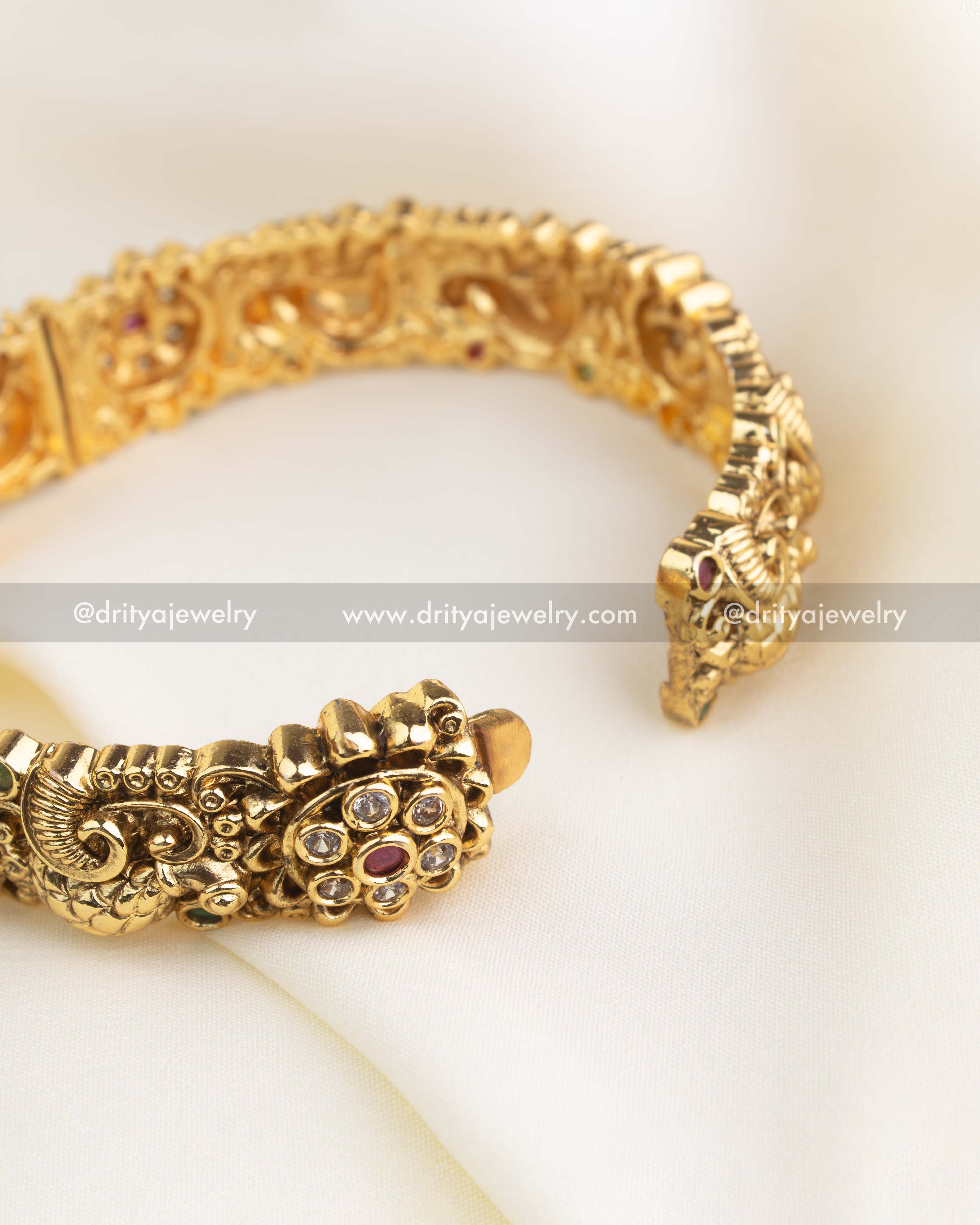 Close-up of openable Nakshi bangle showing intricate antique detailing and hinge design.