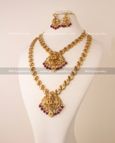 Complete Nakshi bridal set featuring long necklace, short necklace, maang tikka, and dangler earrings with ruby beads and antique finish.