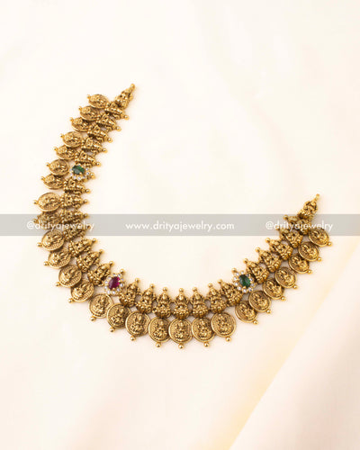 Temple-style short necklace with Lakshmi coin motifs and matching earrings in antique gold finish.