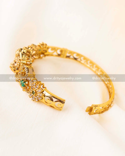 Openable temple-style kada with goddess Lakshmi motif and green stone accents