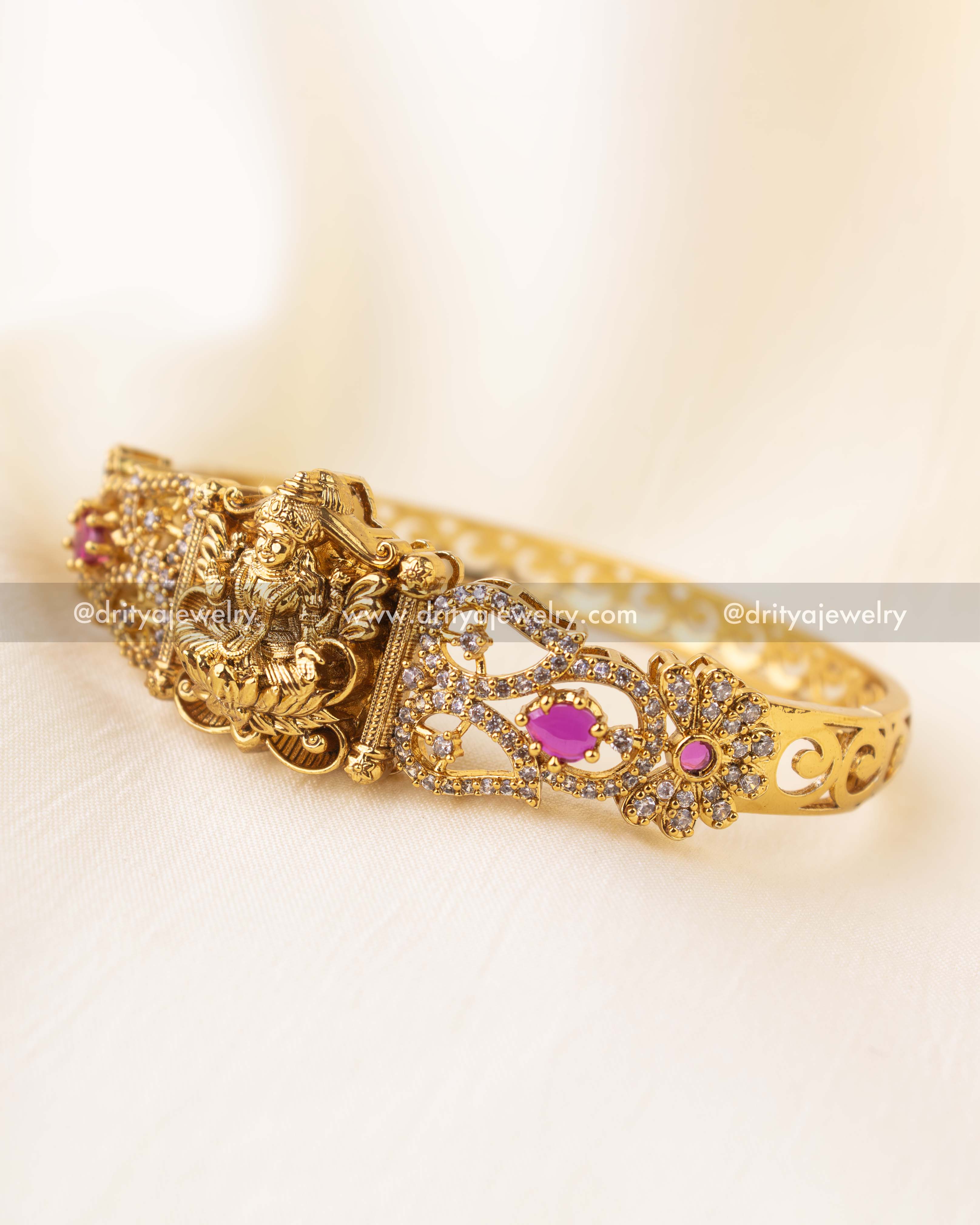 Antique gold Kada with goddess motif and ruby pink accents in openable format