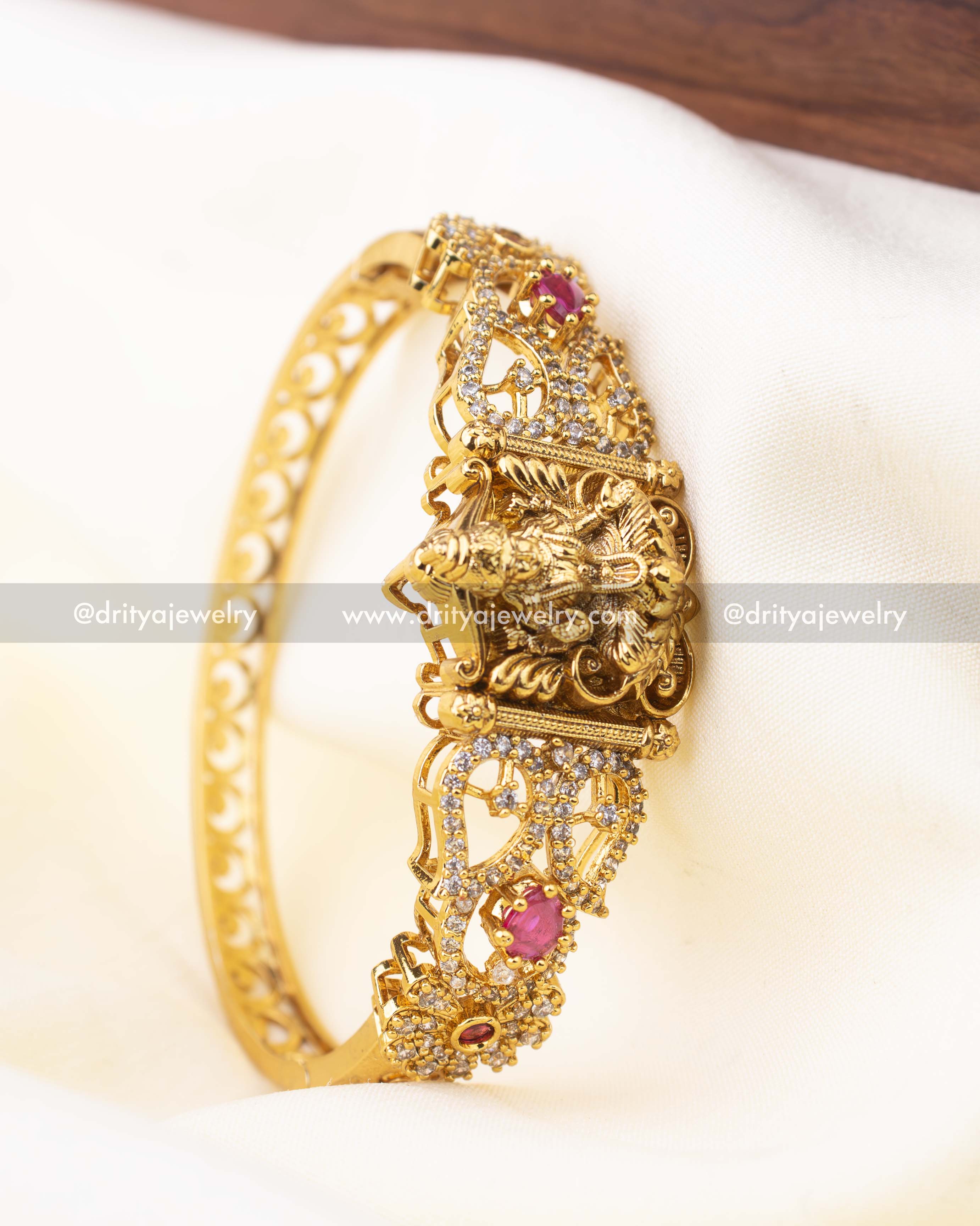 Antique gold Kada with goddess motif and ruby pink accents in openable format