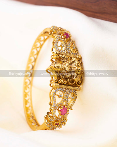 Antique gold Kada with goddess motif and ruby pink accents in openable format