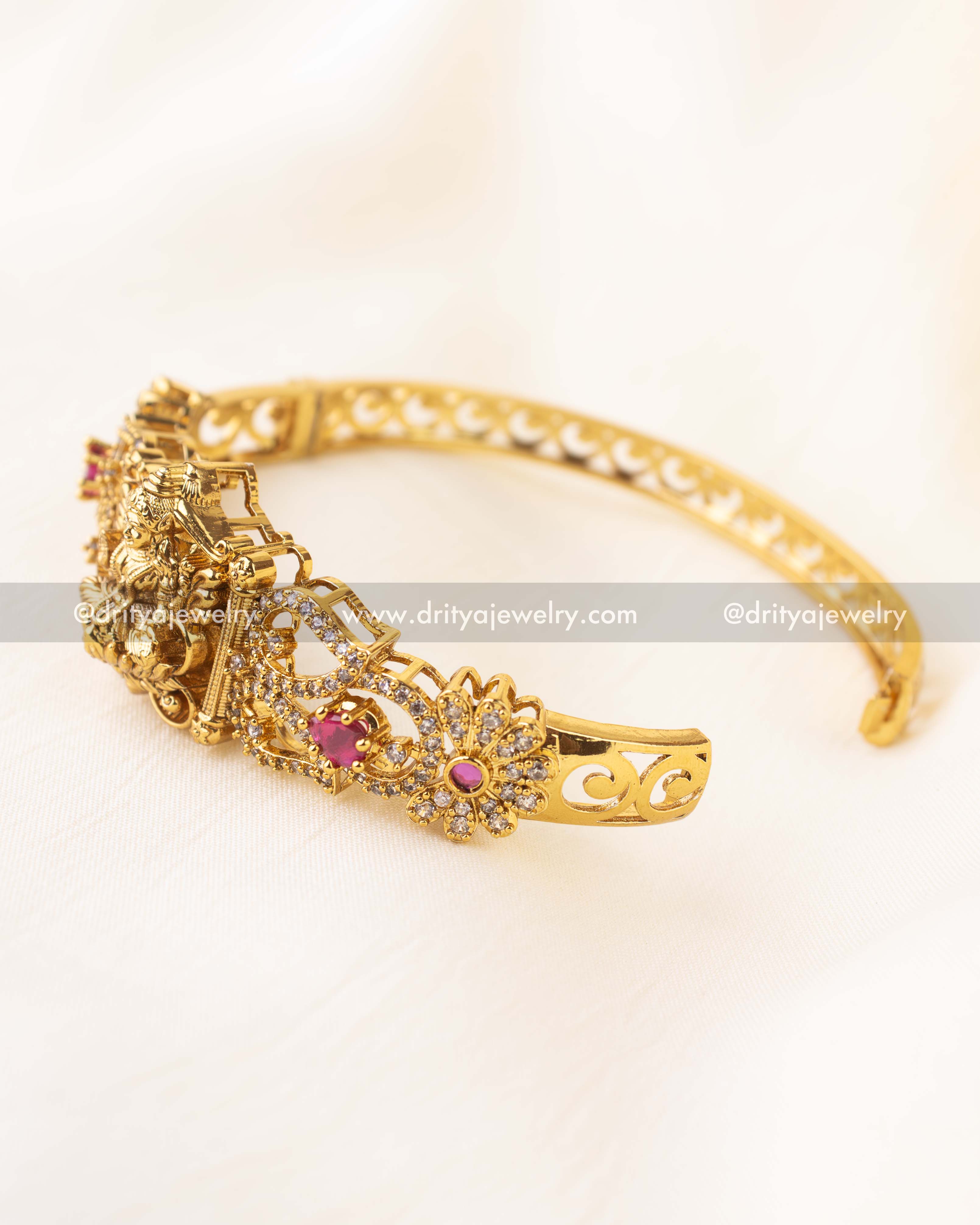 Antique gold Kada with goddess motif and ruby pink accents in openable format