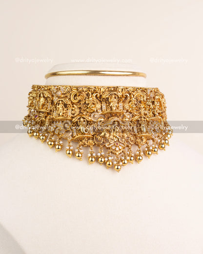 Temple jewelry Nakshi choker with Krishna motif, CZ stones, and golden bead drops.