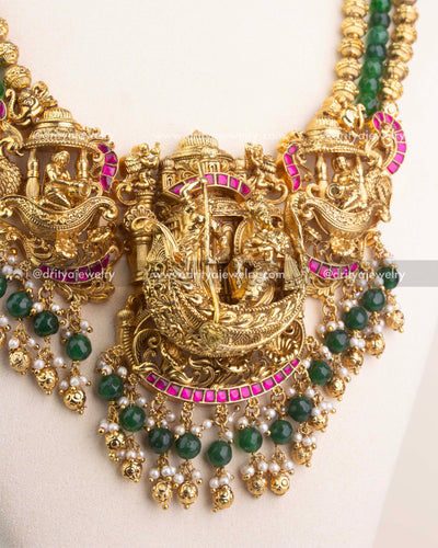 3D Nakshi pendant with Lord Krishna design, ruby Kemp detailing, and pearl-green bead accents.
